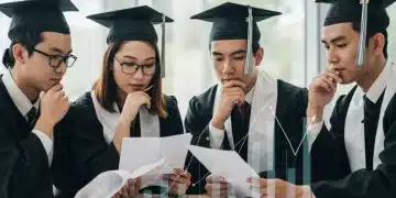Students reviewing federal student loan repayment plan documents for 2025
